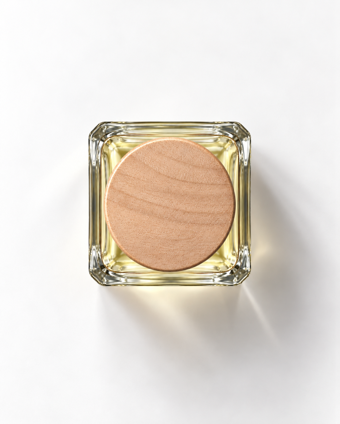 Rainy Rose extrait de parfum from above: pale yellow juice in a square glass bottle with a round wooden cap